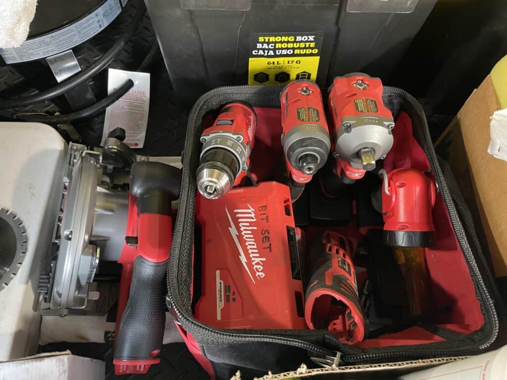 Red Milwaukee M-12 tools in an RV basement